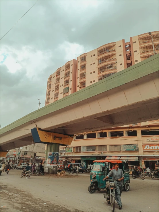 people are riding their motorcycles near a building