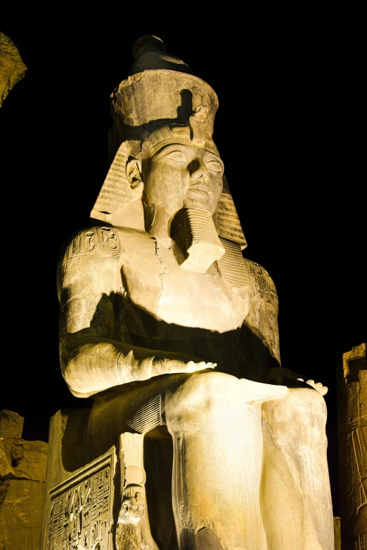 a statue of the pharaoh near a building