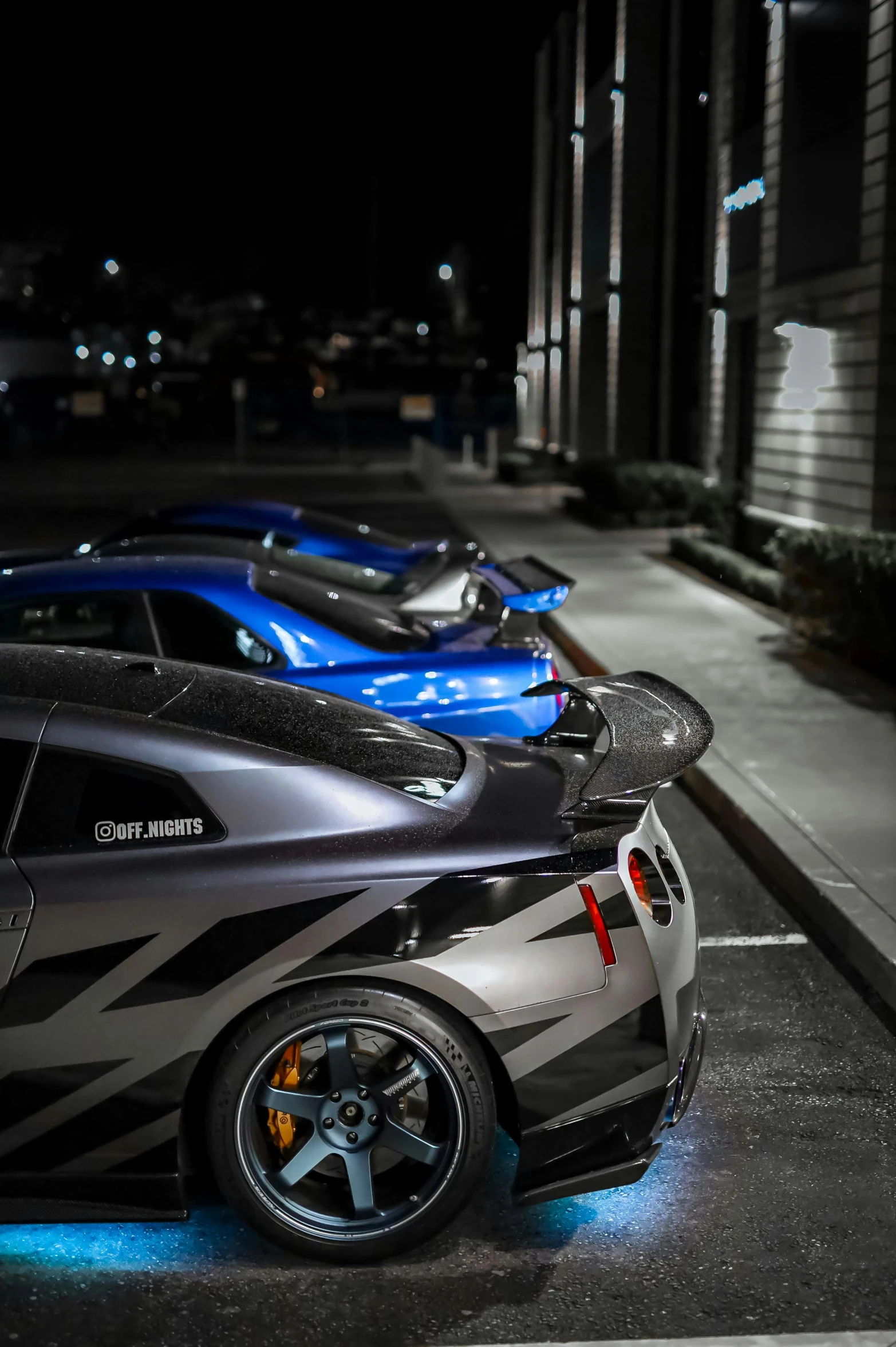 several sports cars parked in the parking lot