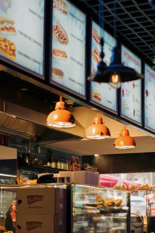 food inside of a restaurant with menus behind the counter