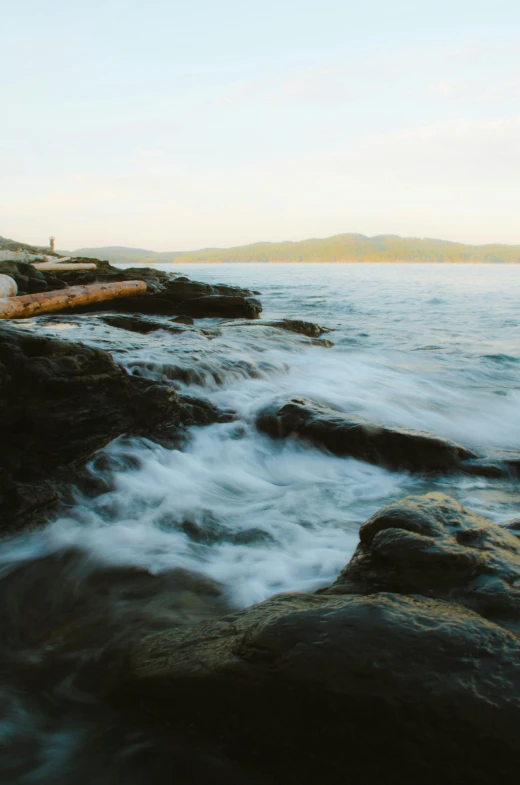 water rushing into the water along side a shoreline