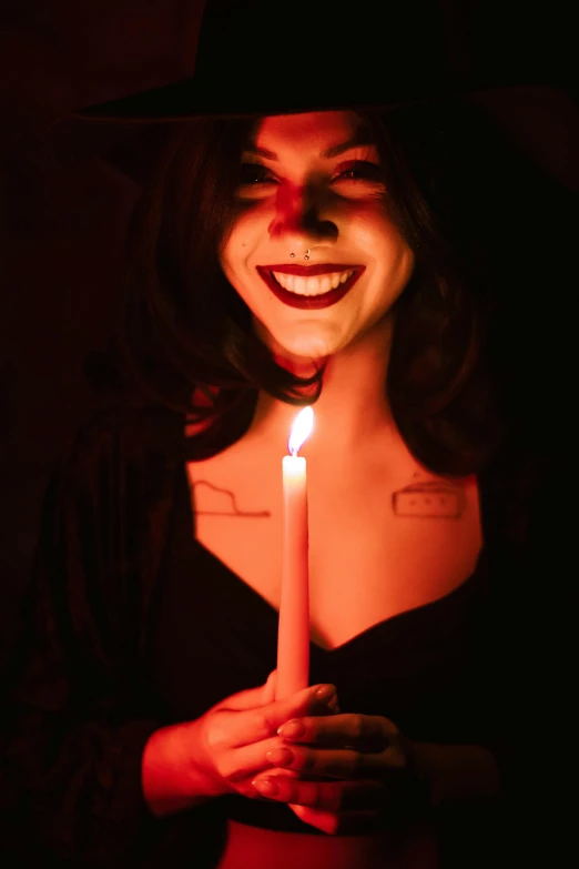 woman in halloween makeup holding a lit candle