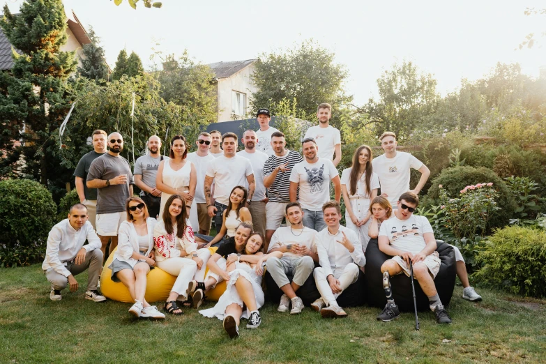 group of men and women posing in front of trees