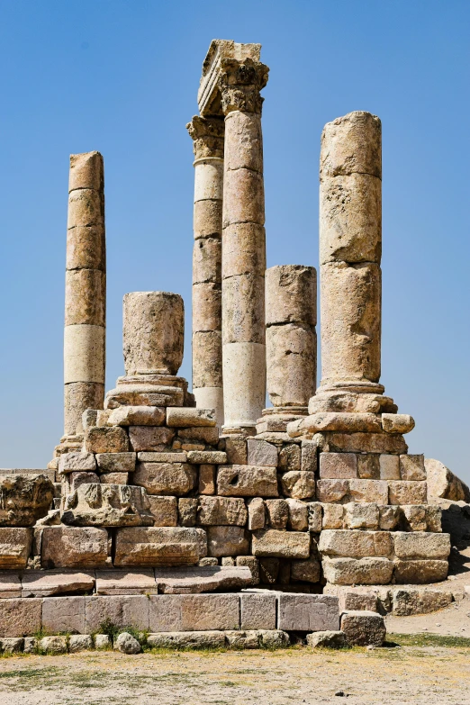 several columns on a rock ledge in the desert