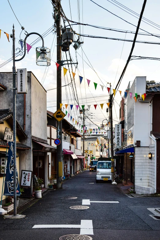 a car parked on a city street lined with shops