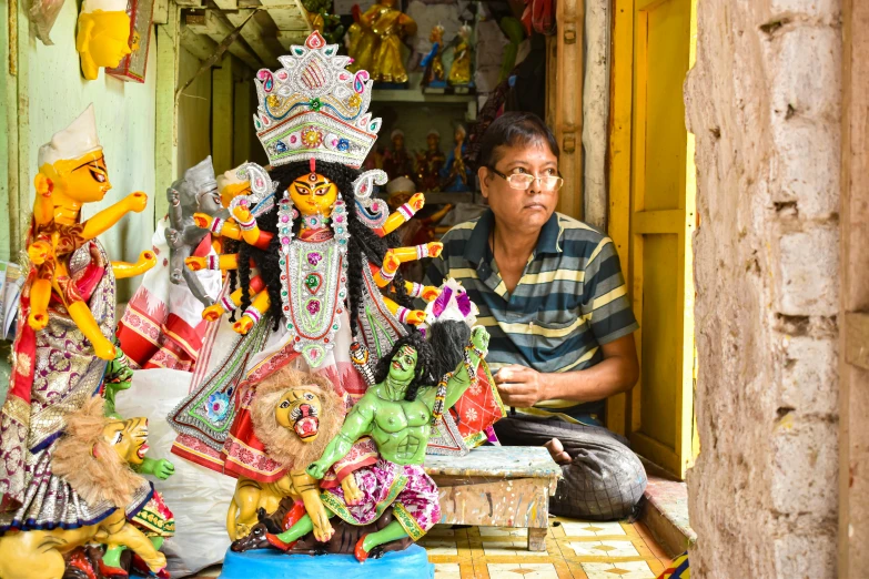 a man standing next to a table covered in colorful items