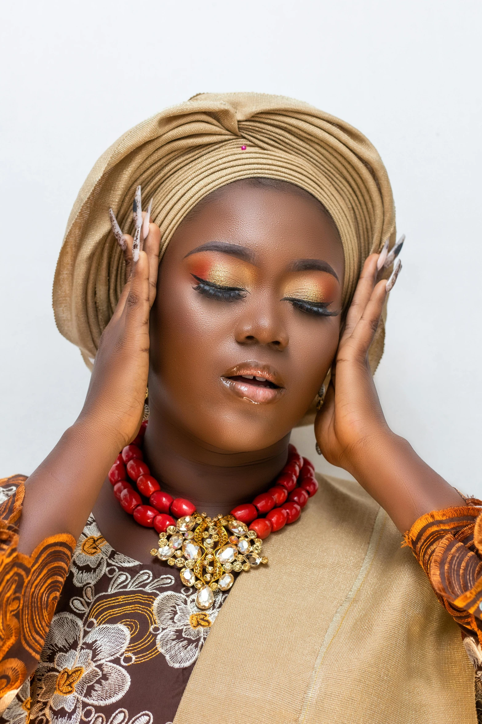 woman in traditional african garb putting on makeup