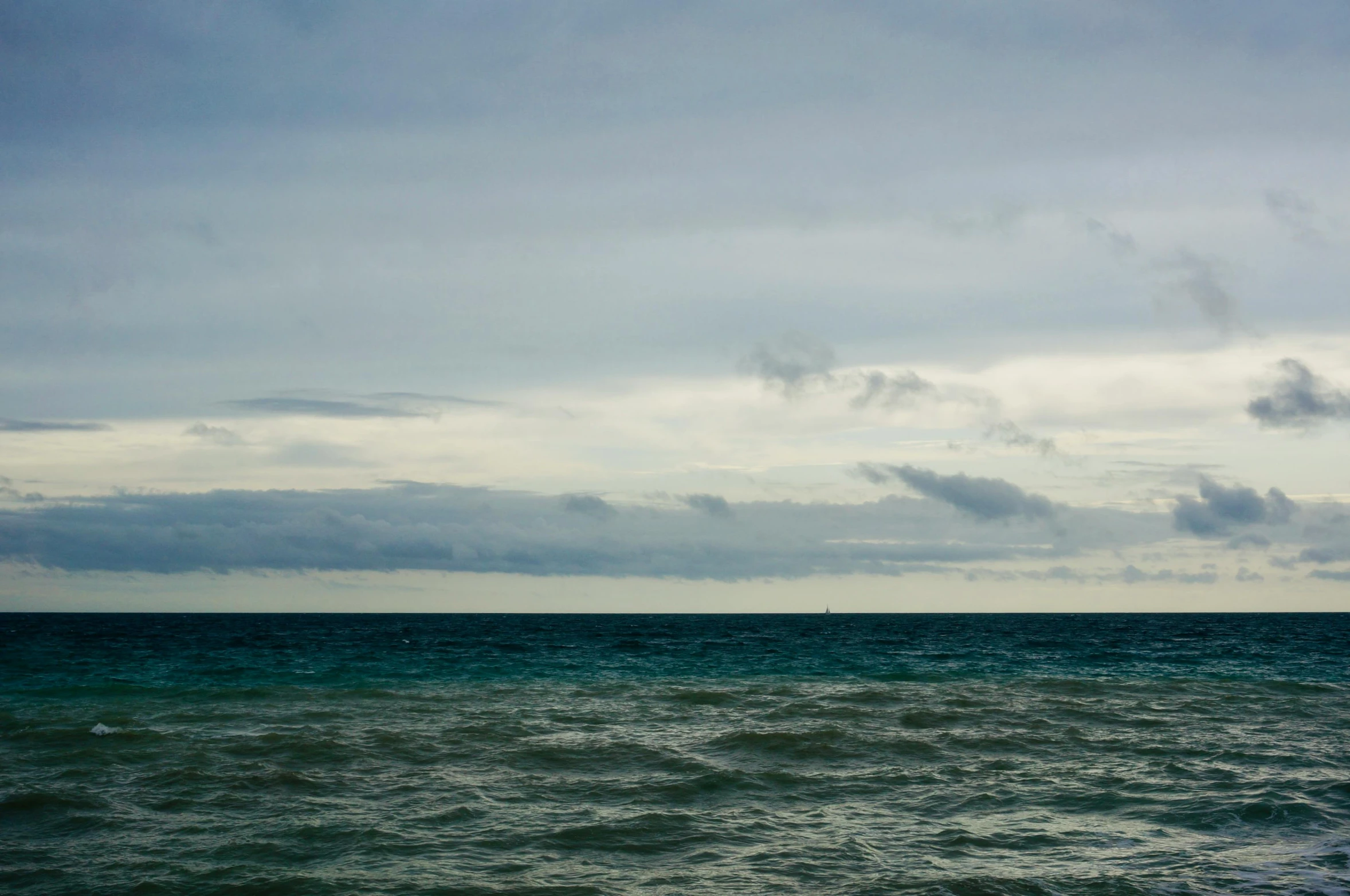 a couple of water boats floating on top of the ocean