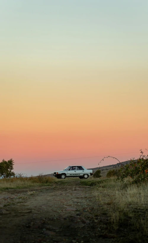 a car parked on the side of a dirt road