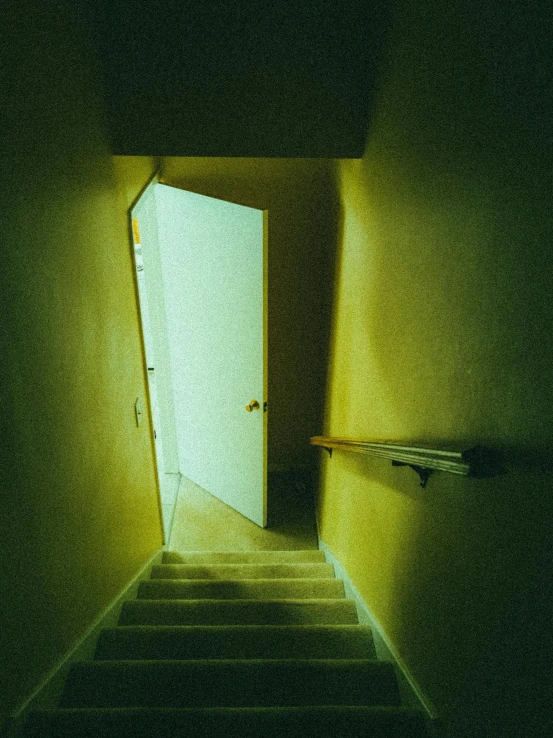 an opening door is at the end of a stairway