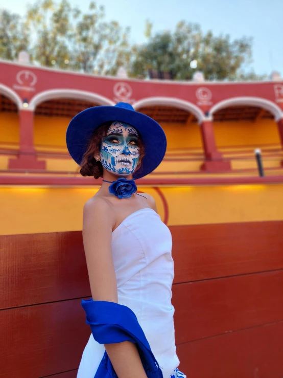 a woman is wearing white and blue makeup