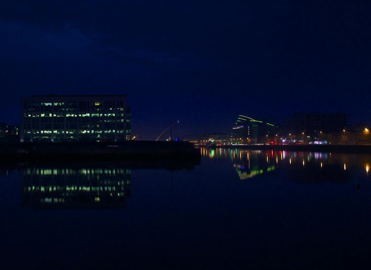 a city in the distance is lit up at night