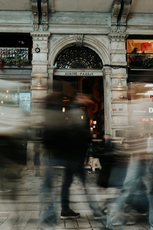 some people walking past a large building with large windows