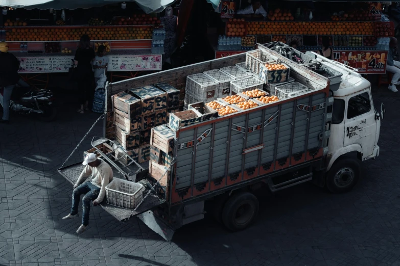 a delivery truck loaded with lots of oranges