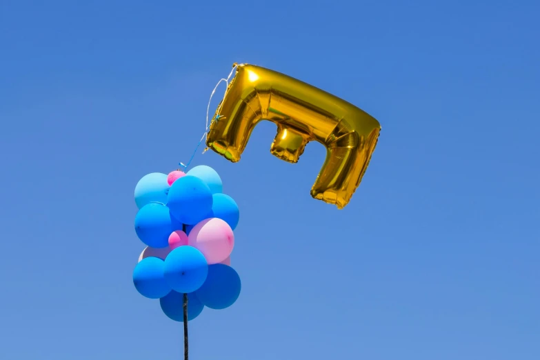 several balloons shaped like letters are floating in the air