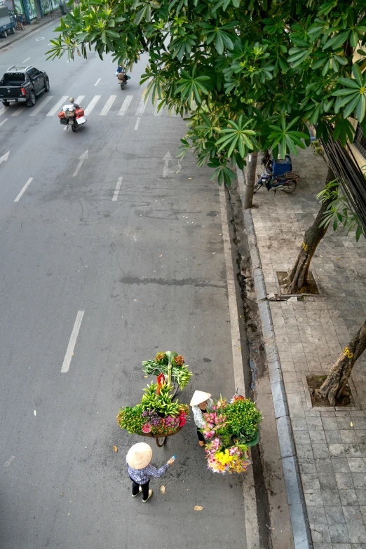 two people that are walking down the street