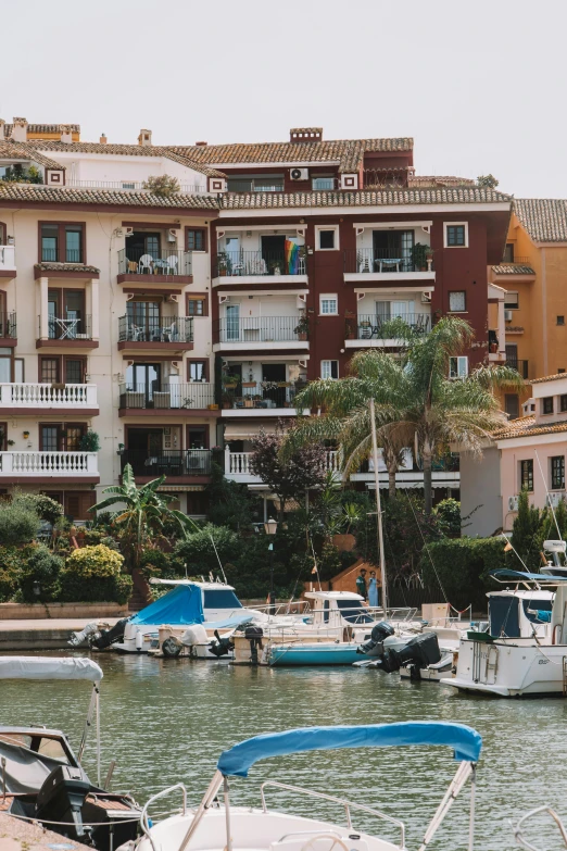 boats on a lake and multiple buildings in the background