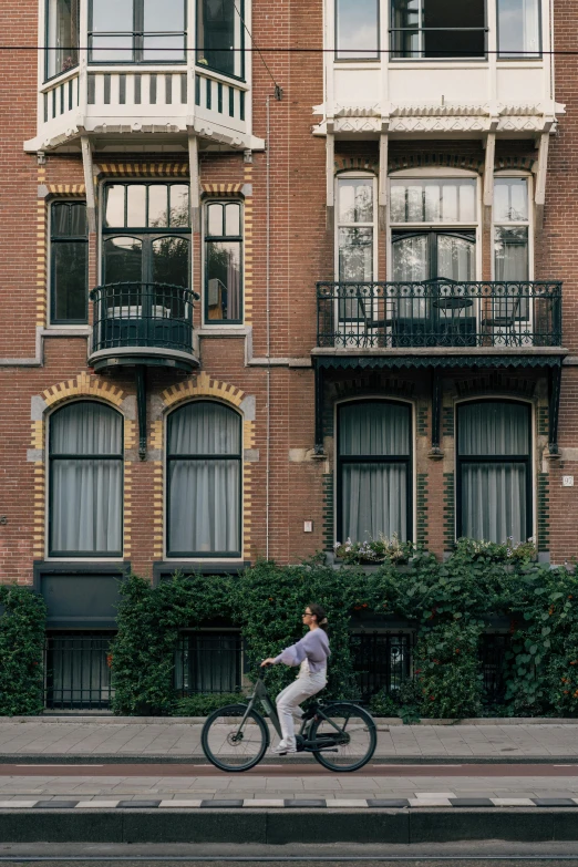 a man riding on a bike down the street