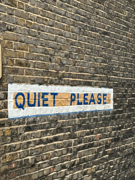 there is a painted sign on the brick wall