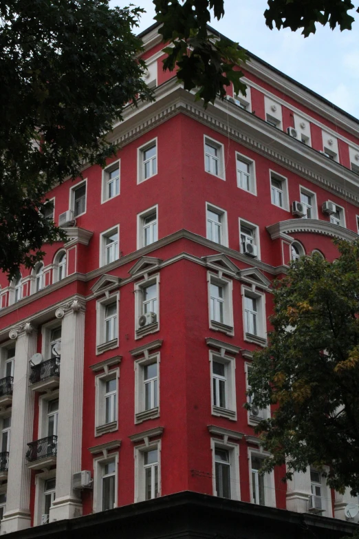 a building with red and white trim, and pillars