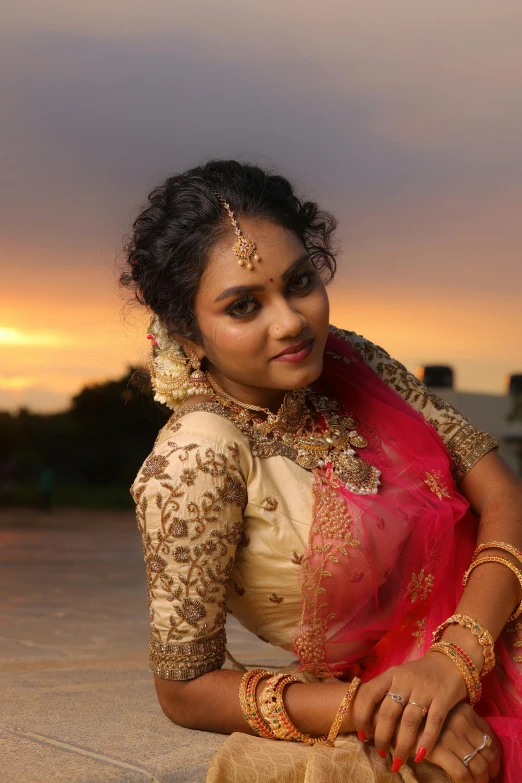 a woman in an indian outfit on the beach