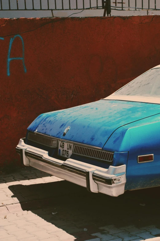 a blue car that is parked on the side of the street