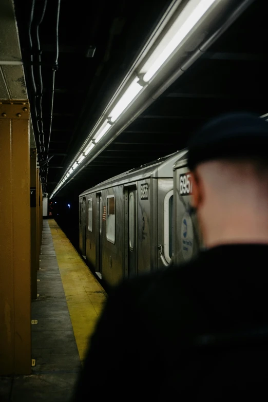 a man is waiting for a train at the station