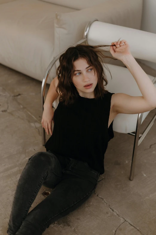 a woman posing on the floor while sitting down