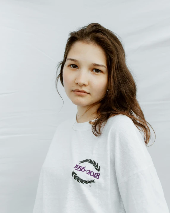 a woman standing in front of a white background