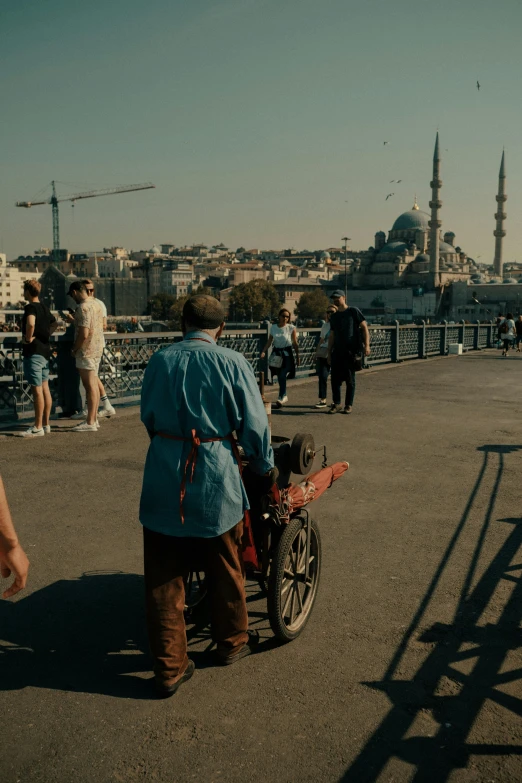 a man rides his bike down a walkway