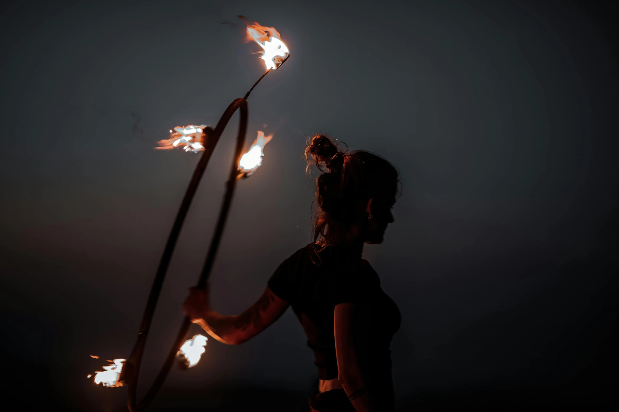 a woman holding torches with torches in her hands