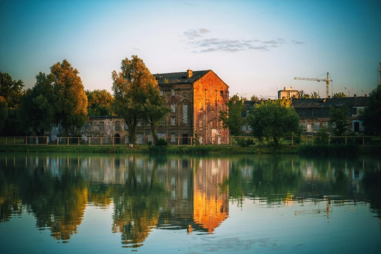 a small building is on the bank of the river