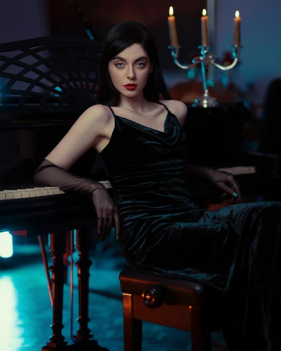 a lady with dark hair sitting at a table in front of an organ