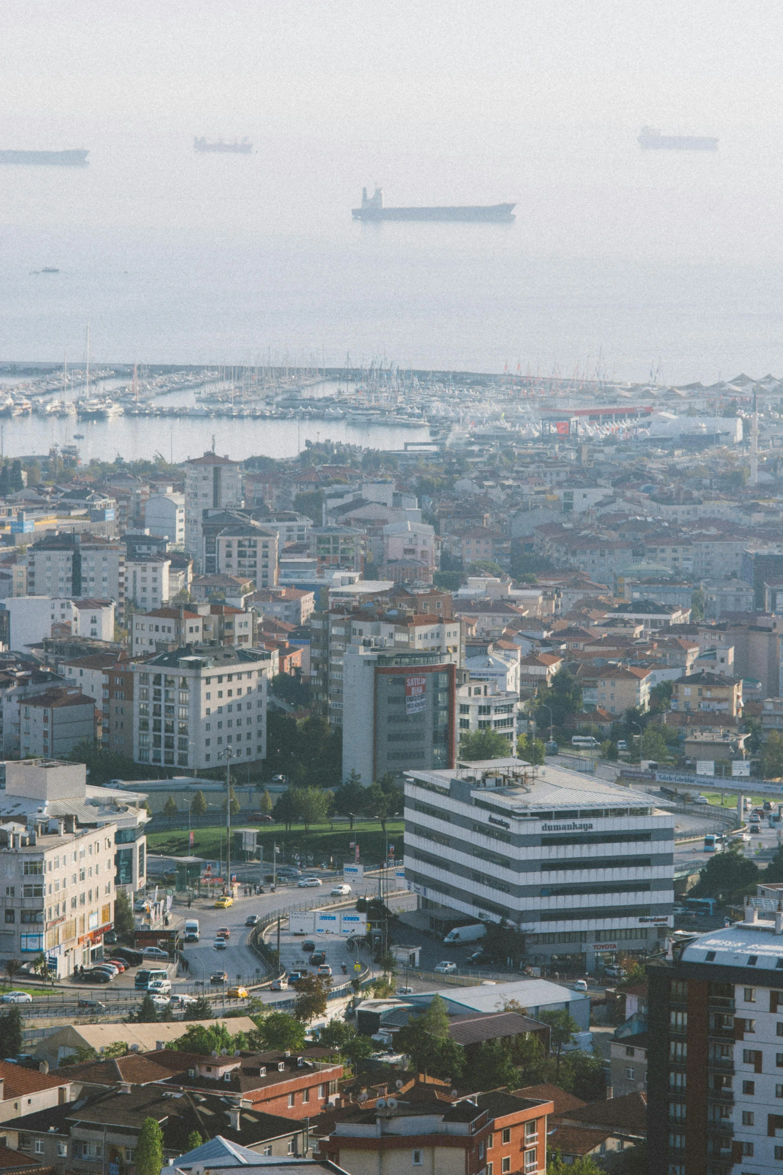 a city skyline with tall buildings and water in the background