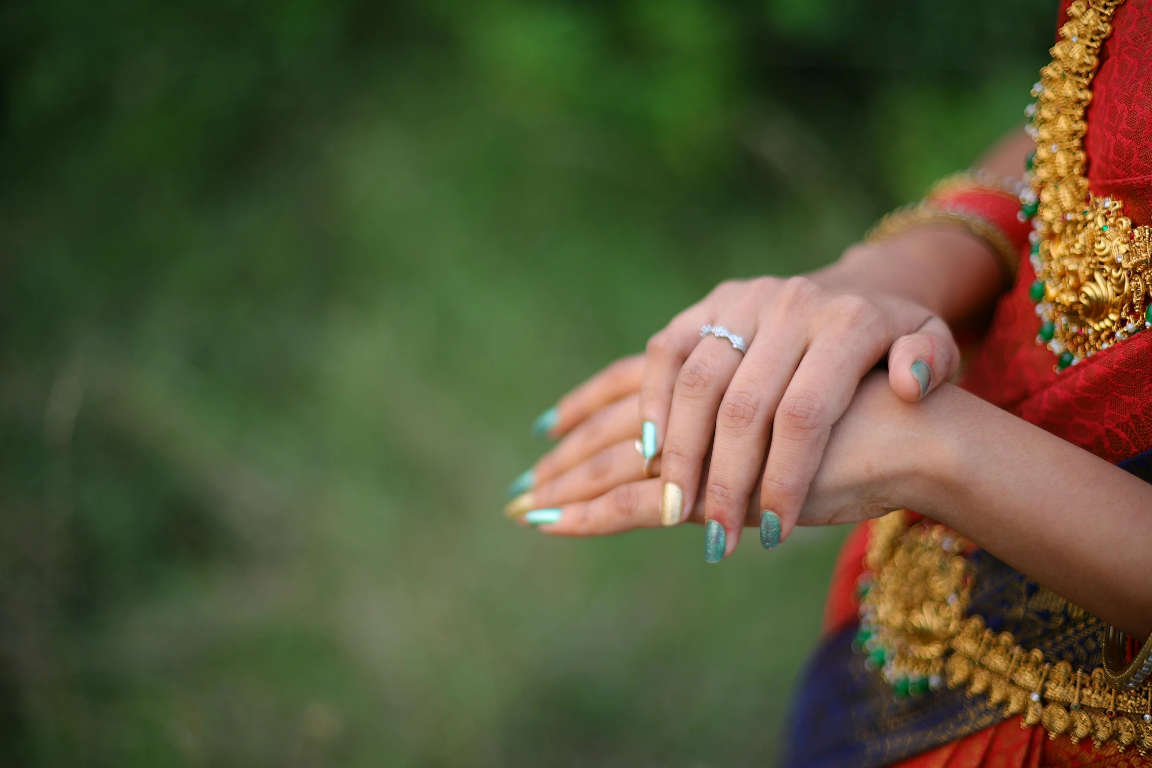 a woman holding onto another person's hand with manicures