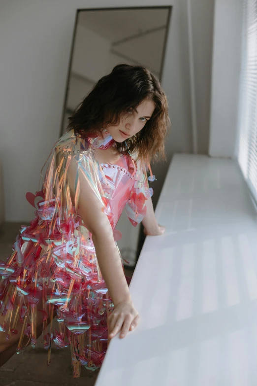 a young child reaching down on a table