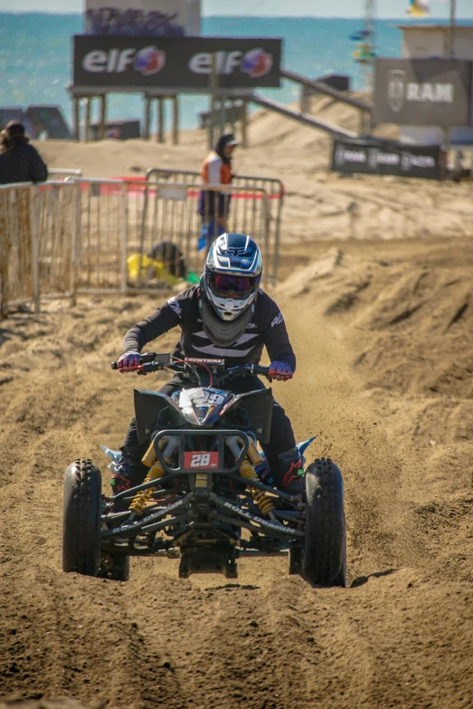 a person on an atv riding down a sandy beach