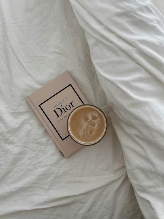 a coffee cup and book on the bed