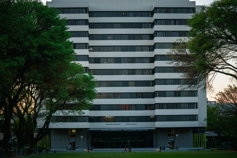 the large white building is built on a hill