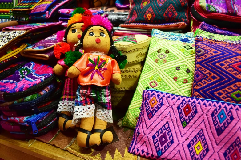 a colorfully colored cloth doll in an ethnic dress