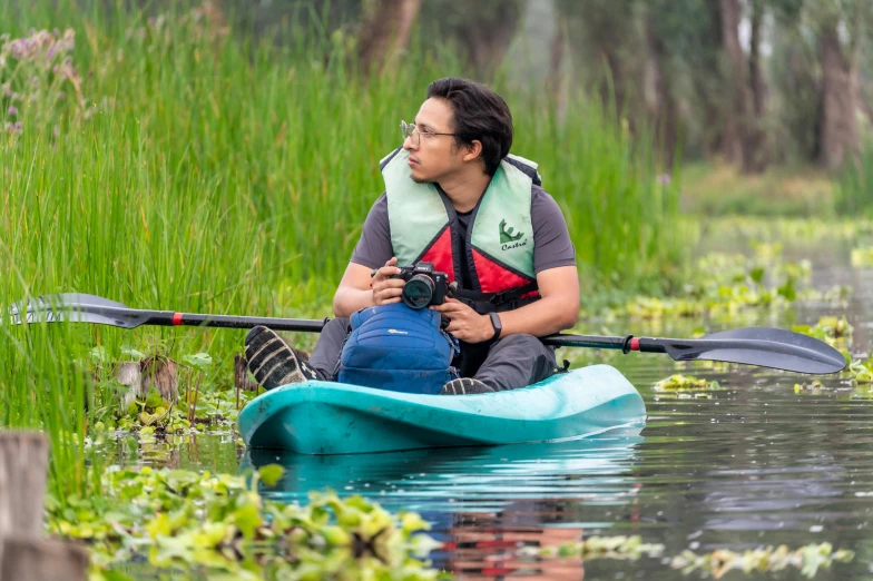 a man riding on the back of a kayak in water