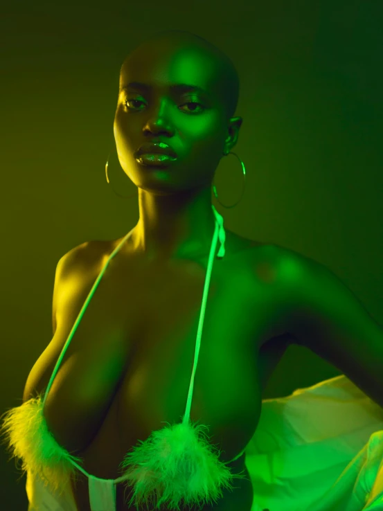 a woman wearing a green neon dress poses for the camera