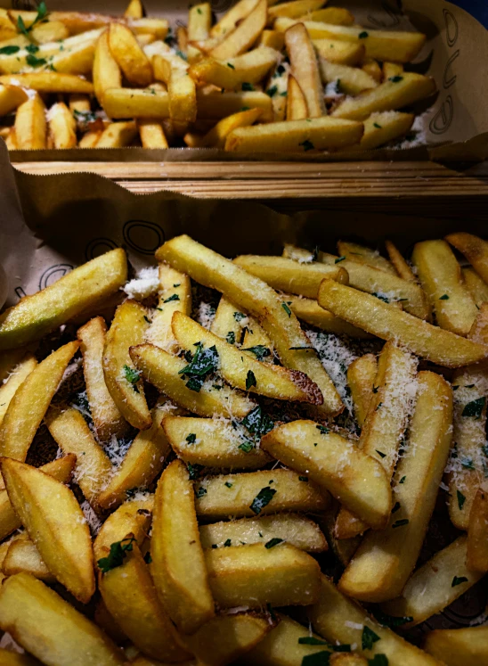 a couple baskets filled with seasoned french fries