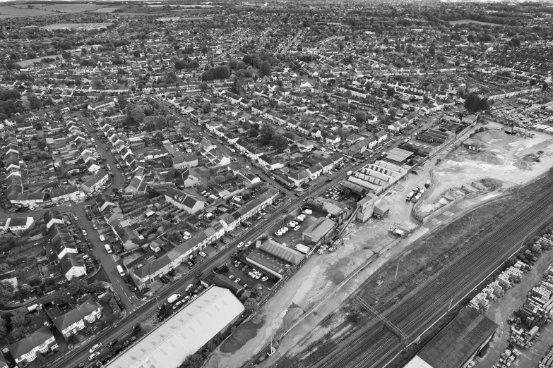 the black and white po shows the cityscape, with large buildings, streets, and a parking lot