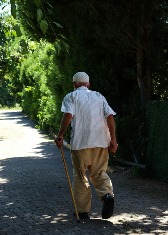 a man walks down the side walk of a road