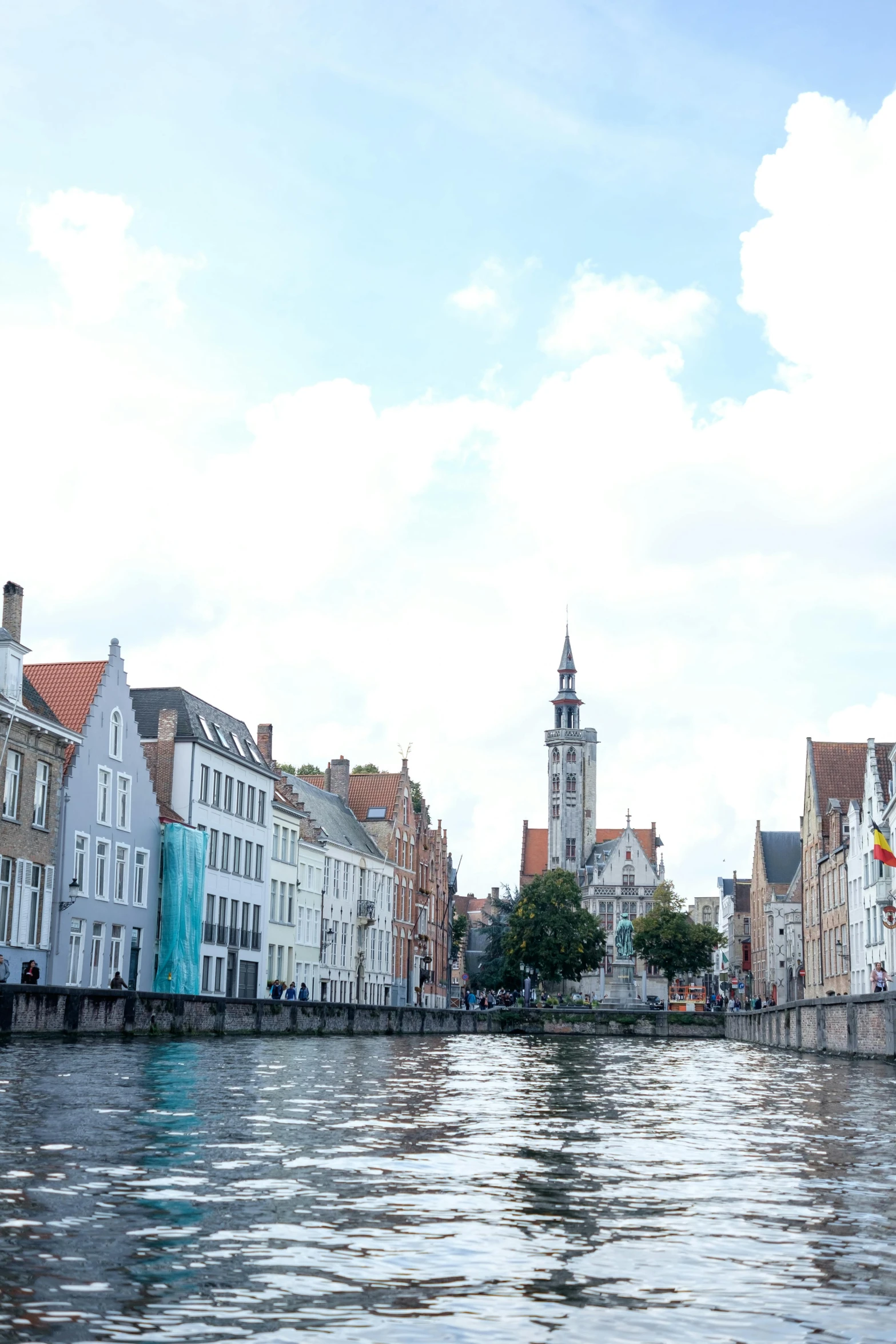 some buildings near a body of water and trees