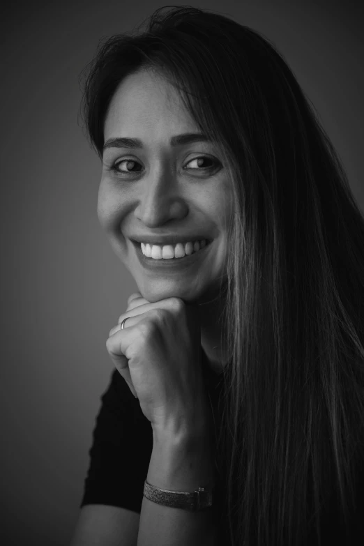 a beautiful woman smiles while posing for the camera