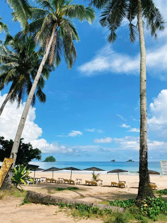 a beach that has several chairs and umbrellas on it