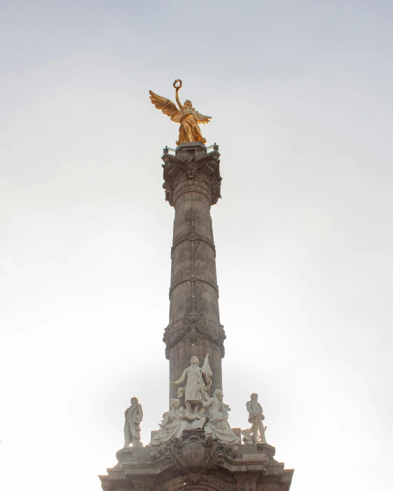 a very tall building with a golden eagle on top