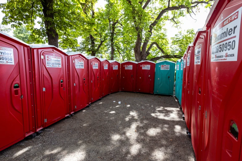 a line up of restroom stalls on the side of the road